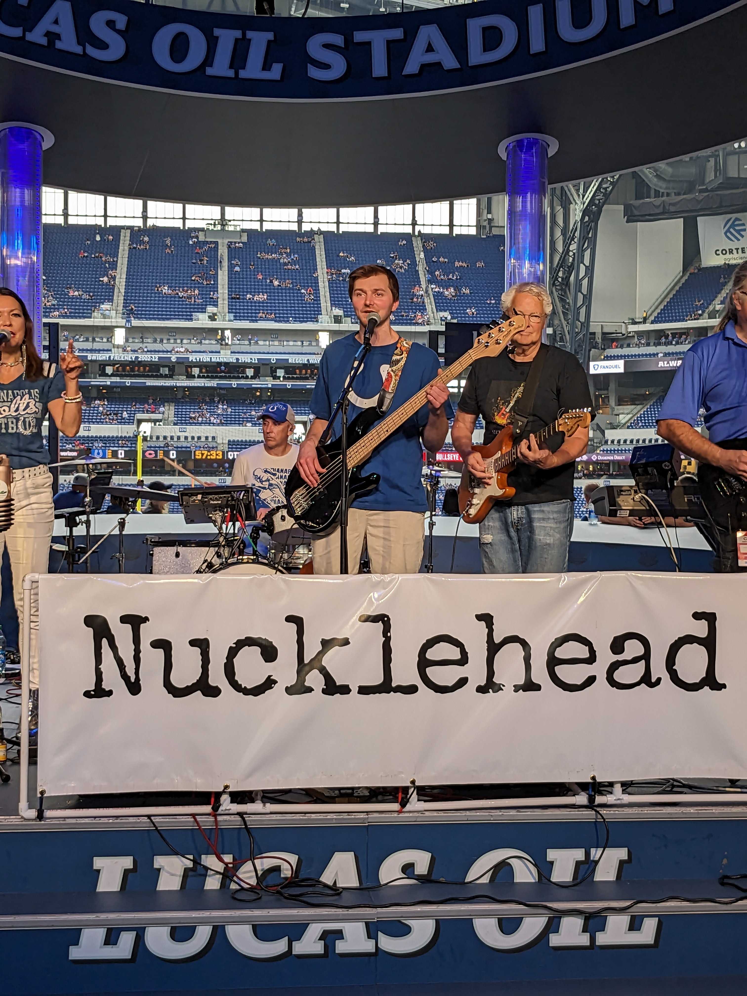 Lee playing bass guitar at a Colts game